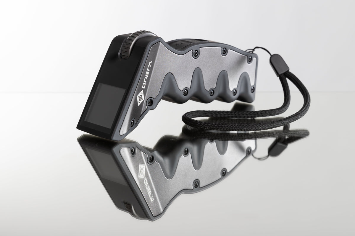 ONSRA NX remote controller with display and wrist strap on a reflective surface