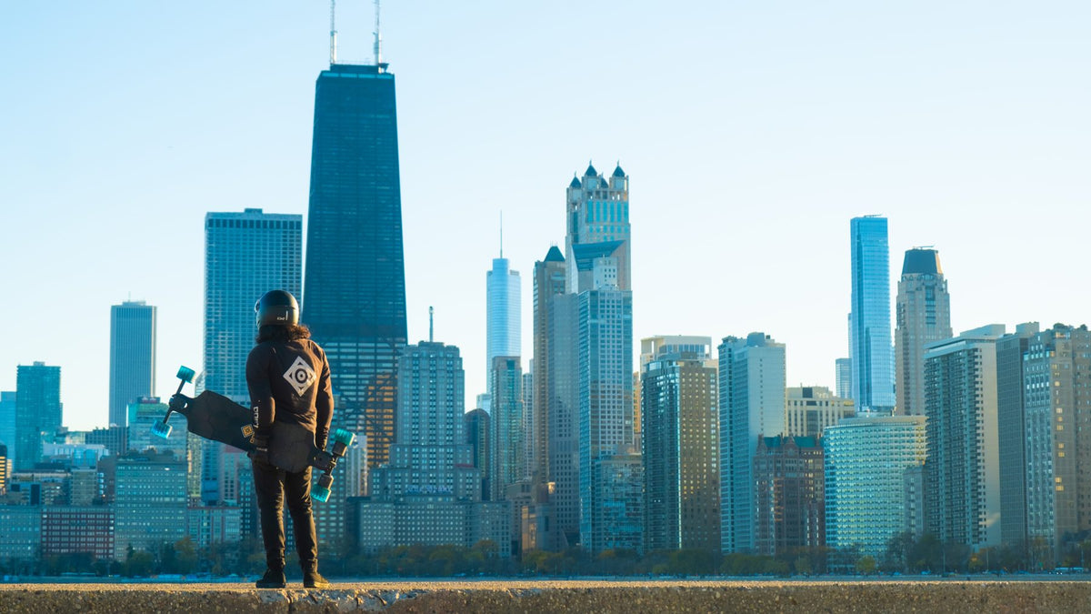 Rider with an electric board in front of the Chicago skyline