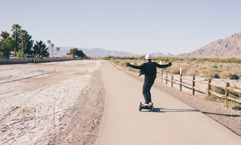 ONSRA VELAR electric skateboard riding on an Australian coastal path with wind, rough pavement and wildlife hazards